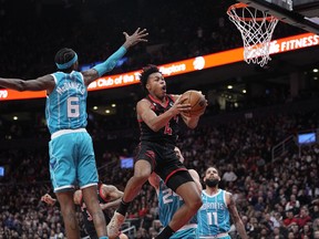 Toronto Raptors forward Scottie Barnes (4) goes up to make a basket against Charlotte Hornets forward Jalen McDaniels on Thursday.