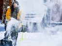 A snow storm is expected to clobber Toronto and surrounding areas with between 10 centimetres to 25 centimetres of the white stuff, starting Wednesday afternoon. Pictured is Donna Barron as she clears snow in Scarborough on Feb. 18, 2022. 