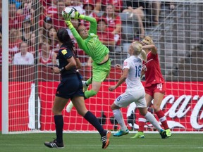 Canada keeper Erin McLeod makes a save in front of England's Katie Chapman (16) during second half FIFA Women's World Cup quarterfinal soccer action in Vancouver, B.C., on Saturday June 27, 2015.