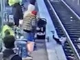 Screen shot of toddler falling onto train tracks after being pushed.