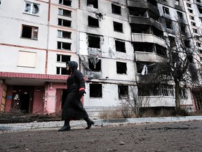 People walk through a neighbourhood destroyed by the Russians on January 4, 2023 in Kharkiv, Ukraine.