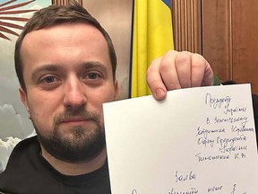 This handout picture released by Deputy head of Ukraine's Presidential Office Kyrylo Tymoshenko on his Telegram channel on January 24, 2023 shows himself holding a handwritten letter the day he presented his resignation to Ukraine's President Volodymyr Zelensky.