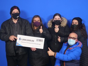 Group of five GTA co-workers holding $1-million cheque from OLG.