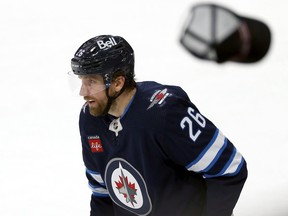 A hat flies past Winnipeg Jets forward Blake Wheeler after his third goal of the game against the Colorado Avalanche in Winnipeg on Tues., Nov. 29, 2022.