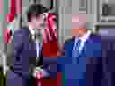 Prime Minister Justin Trudeau shakes hands with Ontario Premier Doug Ford at Queen's Park in Toronto, Aug. 30, 2022.