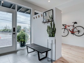 A narrow urban home by Citymaker Homes and Colizza Bruni Architecture has no garage or mudroom so it was designed to have a foyer with elbow room by moving the main living space to the second floor.