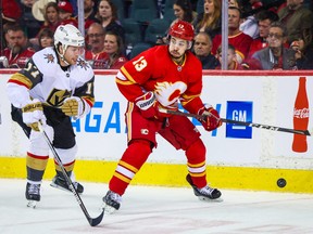 Vegas defenceman and South Grenville native Ben Hutton (left) and Calgary left-winger Johnny Gaudreau battle for the puck during the third period of the Golden Knights' 6-1 win against the Flames on Thursday night.