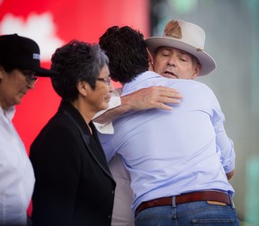 L-R Daisy Wenjack, Pearl Wenjack and Prime Minister Justin Trudeau hugged Gord Downie of the Tragically Hip during WE Day Canada Sunday, July 2, 2017 on Parliament Hill.