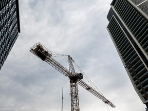 A crane stands between condo buildings in Liberty Village neighbourhood in Toronto on July 13, 2022.