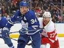 Auston Matthews of the Toronto Maple Leafs skates against Michael Rasmussen of the Detroit Red Wings during an NHL game at Scotiabank Arena on January 7, 2023 in Toronto, Ontario, Canada.  