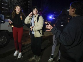 Michigan State University students react during an active shooter situation on campus on February 13, 2023 in Lansing, Michigan. Five people were shot and the gunman still at large following the attack, according to published reports. The reports say some of the victims have life-threatening injuries.