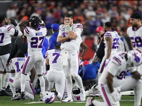 Josh Allen #17 and other members of the Buffalo Bills react to teammate Damar Hamlin #3 being worked on after collapsing against the Cincinnati Bengals during the first quarter at Paycor Stadium on January 2, 2023 in Cincinnati, Ohio.