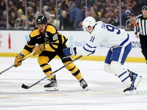 David Pastrnak #88 of the Boston Bruins skates against John Tavares #91 of the Toronto Maple Leafs during the first period at TD Garden on January 14, 2023 in Boston.