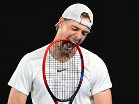 Denis Shapovalov of Canada bites his racquet during the third round singles match against Hubert Hurkacz at the Australian Open.