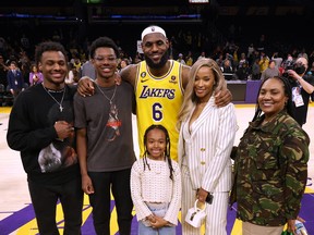 LeBron James #6 of the Los Angeles Lakers poses for a picture with his family at the end of the game, (L-R) Bronny James, Bryce James, Zhuri James Savannah James and Gloria James, passing Kareem Abdul-Jabbar to become the NBA's all-time leading scorer, surpassing Abdul-Jabbar's career total of 38,387 points against the Oklahoma City Thunder at Crypto.com Arena on February 07, 2023 in Los Angeles.