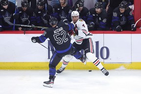 Noel Acciari #52 of the Toronto Maple Leafs work for a loose puck against Seth Jones #4 of the Chicago Blackhawks during the third period at United Center on February 19, 2023 in Chicago, Illinois. (Photo by Stacy Revere/Getty Images)