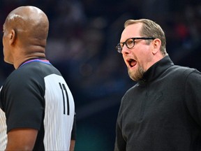 Referee Derrick Collins #11 listens to head coach Nick Nurse argue a call during the first quarter against the Cleveland Cavaliers at Rocket Mortgage Fieldhouse on February 26, 2023 in Cleveland, Ohio.