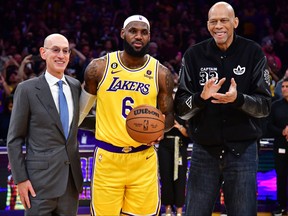 Los Angeles Lakers forward LeBron James (6) poses for a photo after becoming the NBA all time scoring leader with former player Kareem Abdul-Jabbar and commissioner Adam Silver during the second half at Crypto.com Arena Feb 7, 2023.