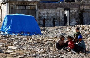 Displaced Syrian children sit at a temporary accommodation centre erected to support people affected by a devastating earthquake in Gaziantep, Turkey, February 14, 2023. REUTERS/Thaier Al-Sudani