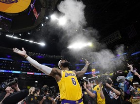 Los Angeles Lakers forward LeBron James tosses powder in the air prior to the team’s NBA basketball game against the Oklahoma City Thunder on Tuesday, Feb. 7, 2023, in Los Angeles. (AP Photo/Ashley Landis)