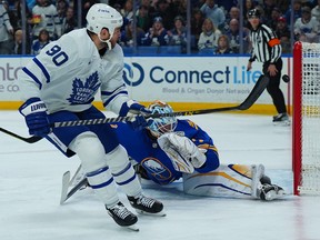 Ryan O'Reilly of the Toronto Maple Leafs scores his second goal of the first period against Ukko-Pekka Luukkonen of the Buffalo Sabres.