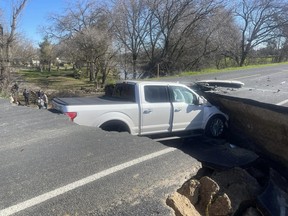 A vehicle is pictured crashing into a hole on a washed-out stretch of roadway in San Joaquin County in a photo shared by the California Highway Patrol on Facebook.