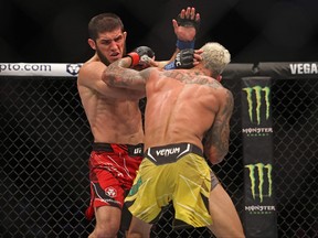 Islam Makhachev (L) competes against Charles Oliveira in the lightweight championship at the Ultimate Fighting Championship (UFC) event at the Etihad Arena in Abu Dhabi on October 22, 2022.