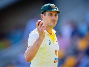 Australia's Pat Cummins gestures after a five wicket haul as he walks off at the conclusion of South Africa's innings during day two of the first cricket Test match between Australia and South Africa at the Gabba in Brisbane on December 18, 2022.