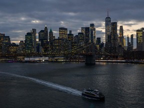 The skyline of lower Manhattan is seen past a ferry on the East River in New York City on Feb. 6, 2023.