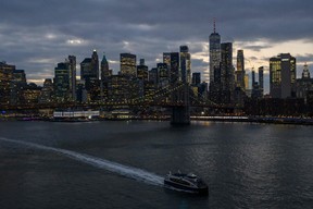The skyline of lower Manhattan is seen past a ferry on the East River in New York City on Feb. 6, 2023.