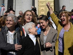 Spain's LGTBI+ president Uge Sangil (left), activist Carla Antonelli (second from left), activist Boti Garcia (centre) and Spain's Minister for Equality Irene Montero (second from right) celebrate in front of the Spanish Congress, in Madrid on Feb. 16, 2023 after the 'transgender ley' was voted.