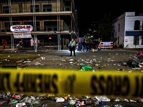 Police officers work at the scene of a shooting that occured during the Krewe of Bacchus parade in New Orleans, February 19, 2023.