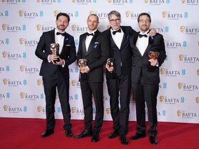 Viktor Prasil, Markus Stemler, Frank Kruse and Lars Ginzel pose with their awards for 'All Quiet on the Western Front' during the EE BAFTA Film Awards 2023 at The Royal Festival Hall in London, Sunday, Feb. 19, 2023.