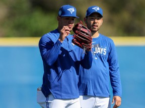 Toronto Blue Jays starting pitcher Jose Berrios (17) and starting pitcher Yusei Kikuchi (16) participate in spring workouts at the Blue Jays Player Development Complex.