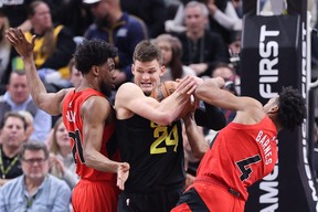 Utah Jazz center Walker Kessler (center) battles for a rebound against Toronto Raptors forward Thaddeus Young (left) and forward Scottie Barnes (right) in the fourth quarter at Vivint Arena Feb 1, 2023; Salt Lake City, Utah. Rob Gray-USA TODAY Sports