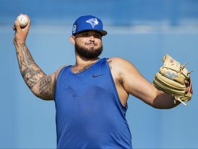 Toronto Blue Jays starting pitcher Alek Manoah warms his arm up during baseball spring training in Dunedin, Fla., on Sunday, February 19, 2023.