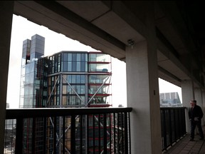 Visitor looks out from the Viewing Level towards a luxury block of flats from the Tate Modern gallery in London, Feb. 12, 2020.
