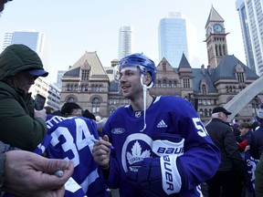 Toronto Maple Leafs wingerMichael Bunting signs an autograph during an outdoor practice at Nathan Phillips Square on Sunday.