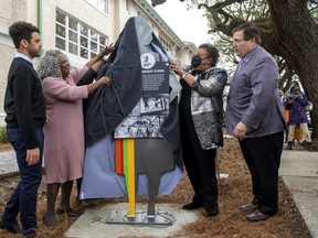 Lt. Gov. Billy Nungessor, right, watches as Leona Tate, left, helps unveil a new Louisiana Civil Rights Trail marker outside the Tate, Etienne, Prevost Center, formerly known as McDonogh 19 Elementary School during a ceremony Tuesday, Feb. 1, 2022, in New Orleans, honouring Tate, Gail Etienne, and Tessie Prevost, who were the first Black students to integrate a Louisiana school in November 1960.