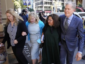 Steve Johnson, right, with his sisters, Terry, left, and Rebecca and his wife Rosemarie, second right, arrive at the Supreme Court in Sydney, Monday, May 2, 2022, for a sentencing hearing in the murder of Scott Johnson, Steve, Terry and Rebecca's brother.