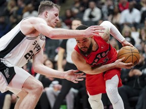 Raptors guard Fred VanVleet tries to avoid San Antonio Spurs centre Jakob Poeltl  during Wednesday night's game in Toronto. Poeltl was traded back to the Raptors the following day.