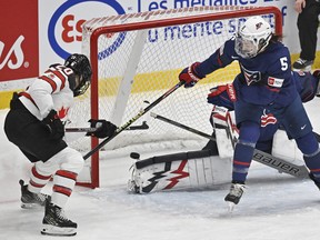 Team Canada Sarah Nurse, left, scores against team USA as Megan Keller (5) defends during first period action at the Rivalry Series, Monday, February 20, 2023 in Trois-Rivieres, Quebec.