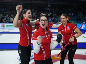 Kerri Einarson and her teammates celebrate after winning their fourth straight Canadian women's curling championship on Sunday.