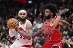 Raptors' Gary Trent Jr. (left) protects the ball from Chicago Bulls' Coby White during the second half in Toronto, on Tuesday, February 28, 2023. 