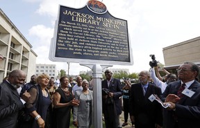 Members of the “Tougaloo Nine” unveil the newest Mississippi Freedom Trail marker recognizing them for their peaceful sit-in at the then whites only Jackson Municipal Library, Thursday, Aug. 17, 2017. The nine people arrested on March 27, 1961, were students at the private Tougaloo College. (AP Photo/Rogelio V. Solis)