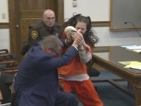 Taylor Schabusiness attacks her attorney, Quinn Jolly, in Brown County court in Green Bay, Wis., on Tuesday, Feb. 14, 2023. (WLUK/Tim Flanigan via AP)