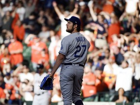Los Angeles Dodgers starting pitcher Trevor Bauer (27) watches the solo home run of Houston Astros' Jose Altuve during the first inning of a baseball game, Wednesday, May 26, 2021, in Houston.