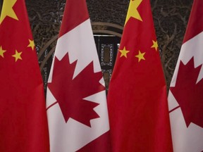 Canadian and Chinese flags taken prior to a meeting with Prime Minister Justin Trudeau and China's President Xi Jinping at the Diaoyutai State Guesthouse in Beijing. on Dec. 5, 2017 (FRED DUFOUR /POOL/AFP via Getty Images)