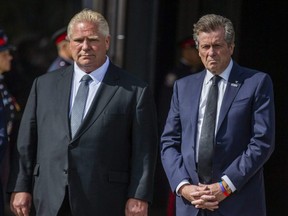 Ontario Premier Doug Ford (left) and Toronto Mayor John Tory attend the funeral for Const. Andrew Hong at the Toronto Congress Centre, Sept. 21, 2022.