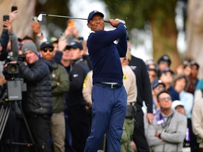 Tiger Woods plays his shot onto the thirteenth hole fairway from the rough during the first round of The Genesis Invitational golf tournament Feb 16, 2023.  Gary A. Vasquez-USA TODAY Sports